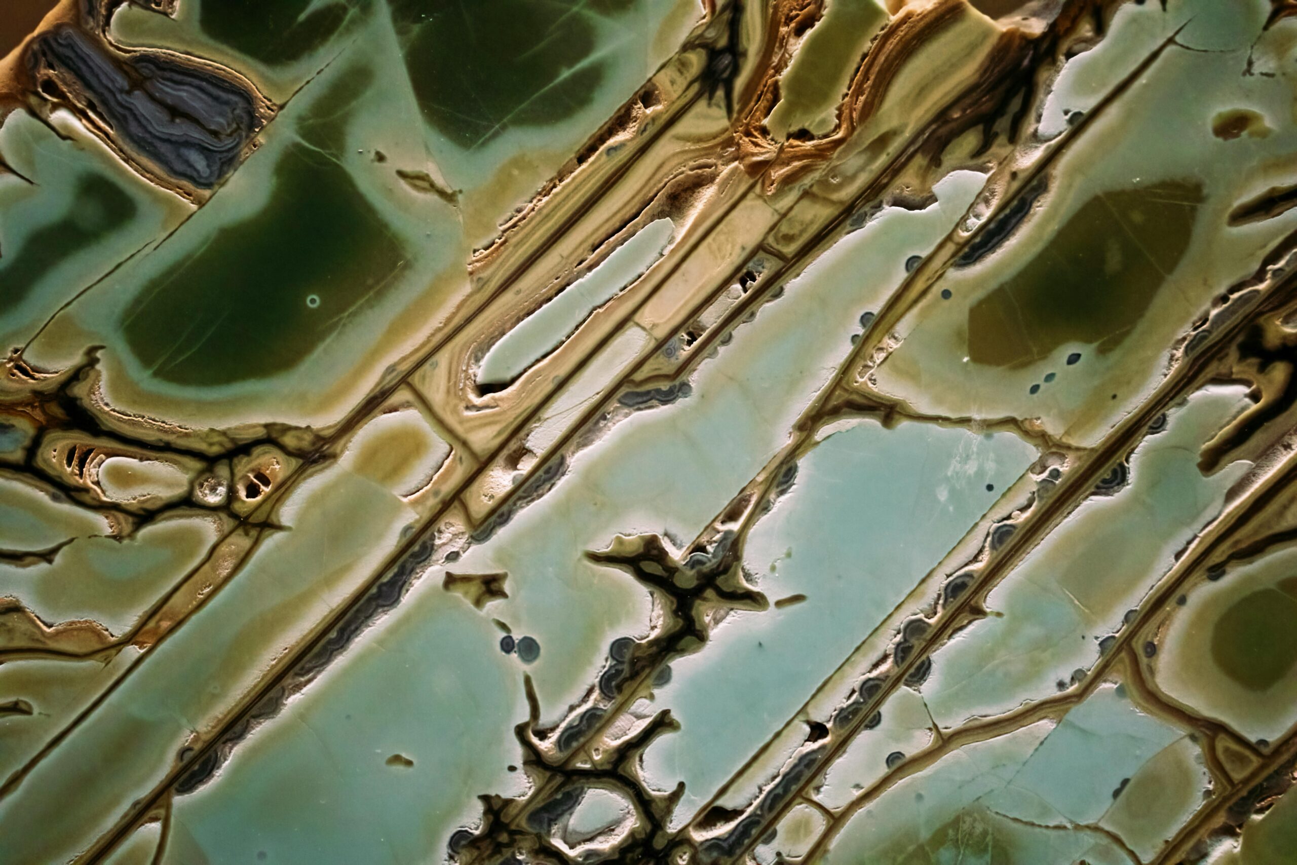 Intricate abstract green marble texture resembling natural geology formations.