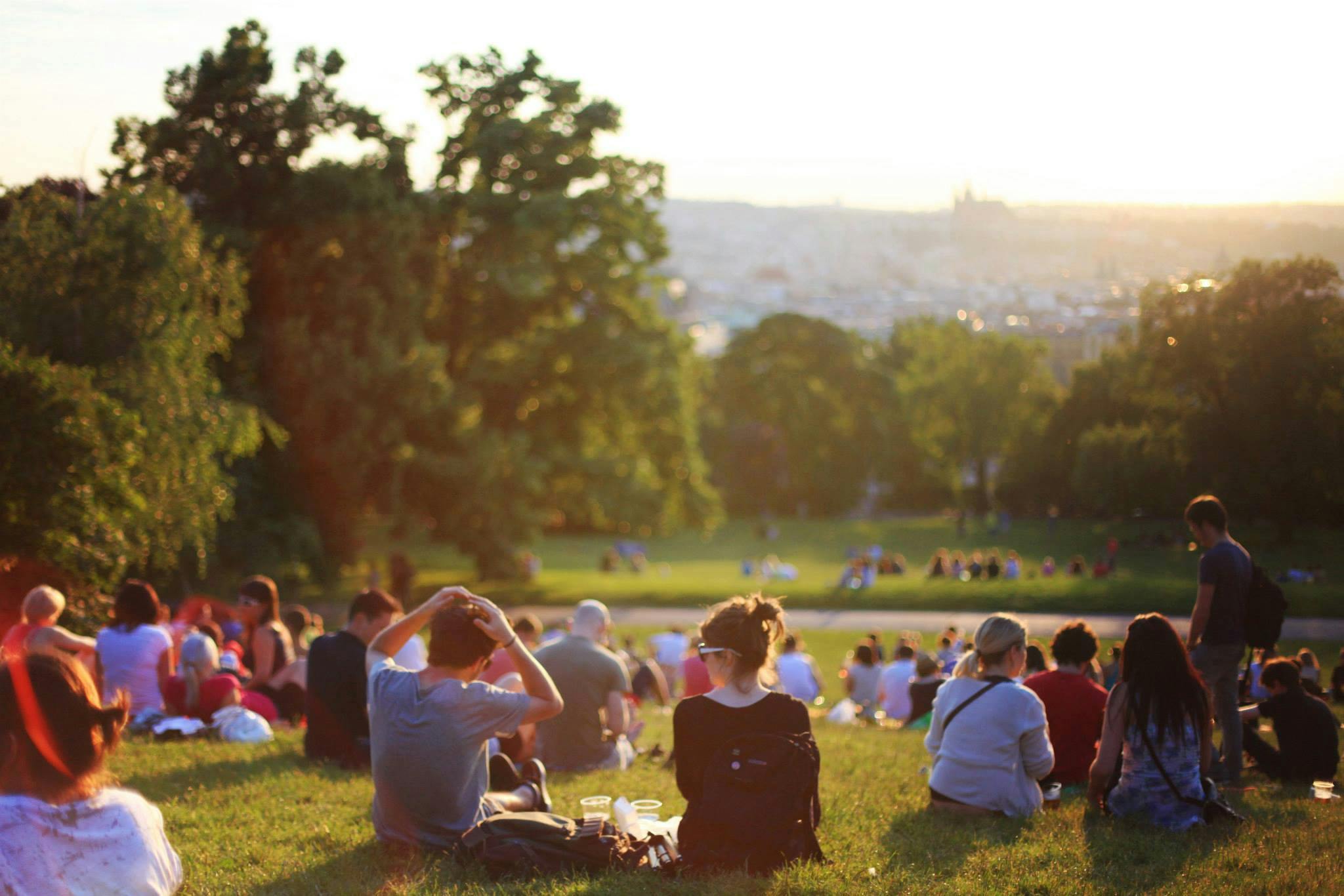 About People relaxing and enjoying a sunny day in a bustling city park.